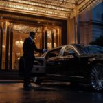 Gallery chauffeur service driver holding open door sleek black limousine client rotated 1.jpg